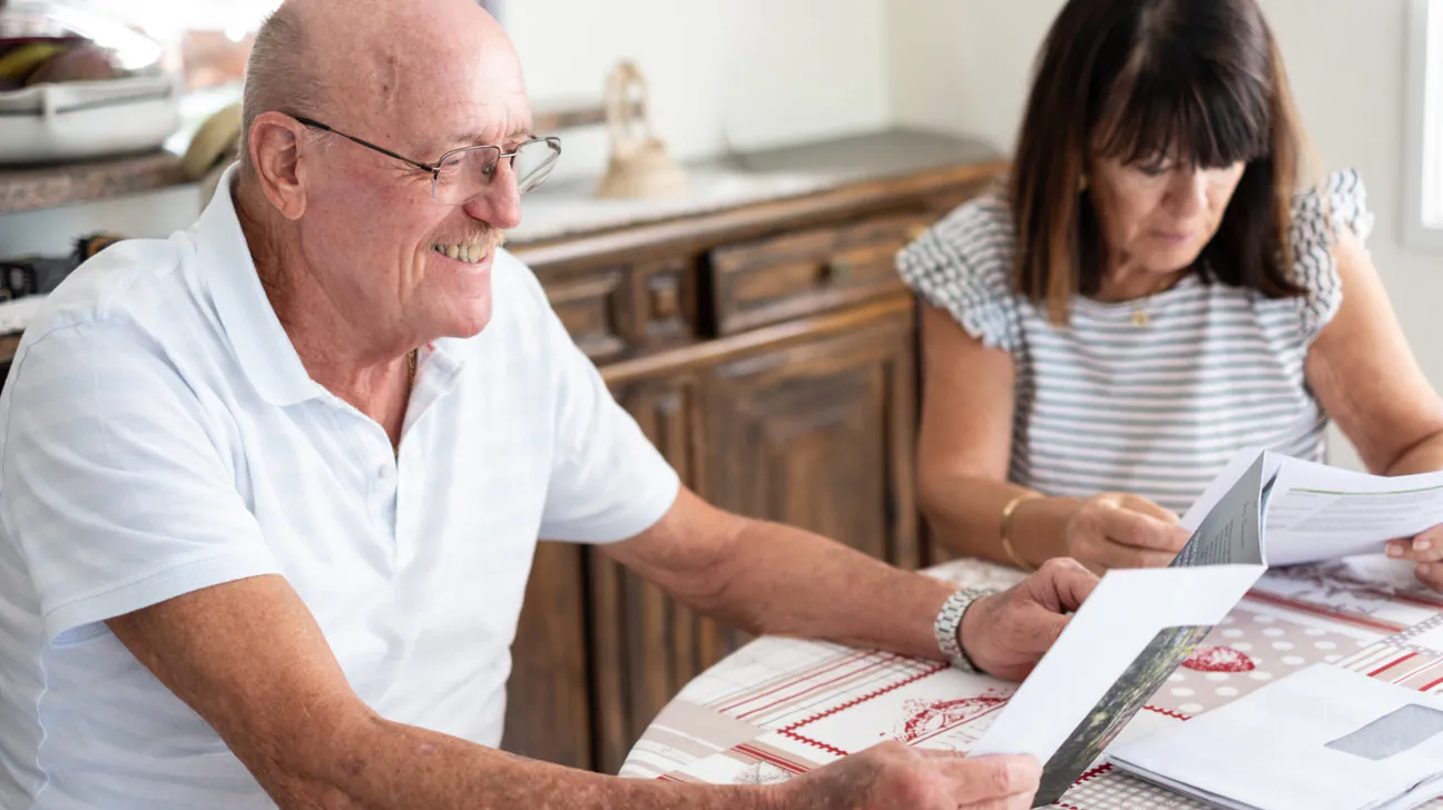 Senior couple reviewing documents together at home