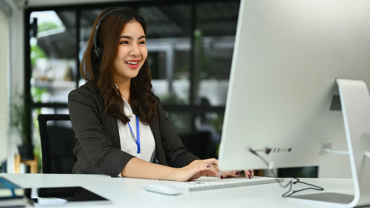 Customer support specialist answering calls at her desk